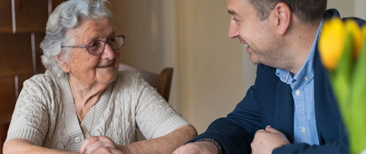 Senior woman having a discussion with a caretaker