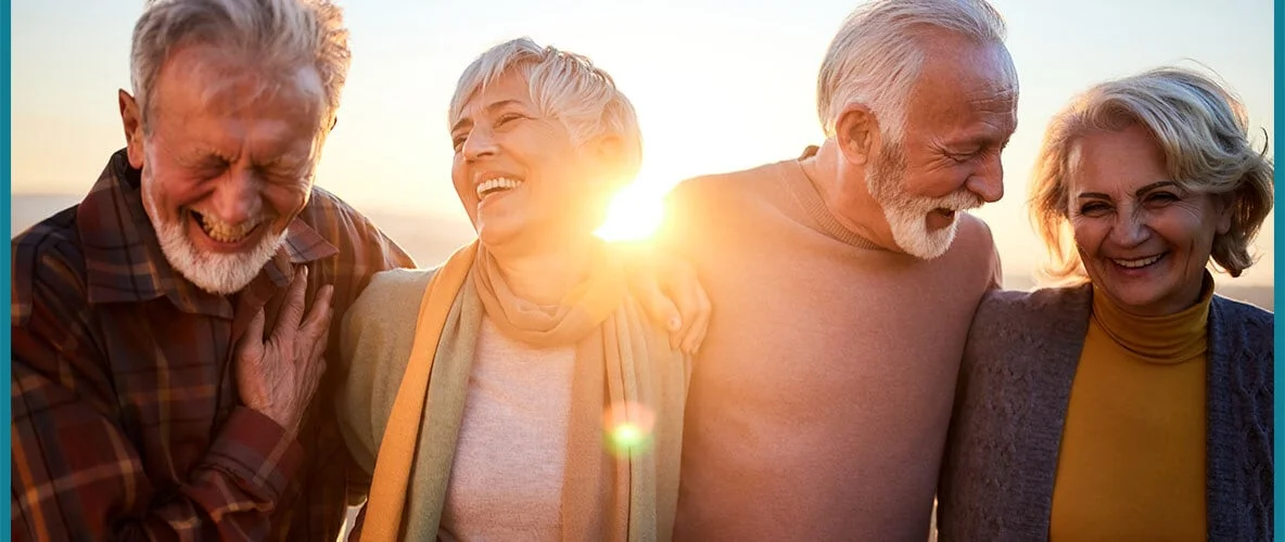 Group of older adults laughing together during social activity
