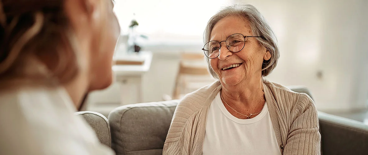 Active senior woman speaking with a person in the foreground
