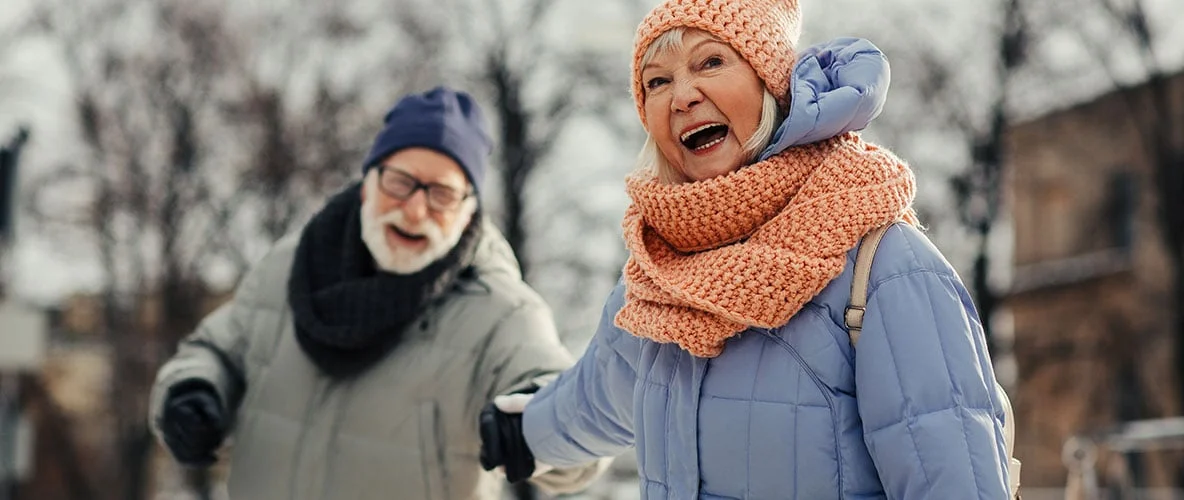 Seniors bundled in winter clothing outdoors during cold weather