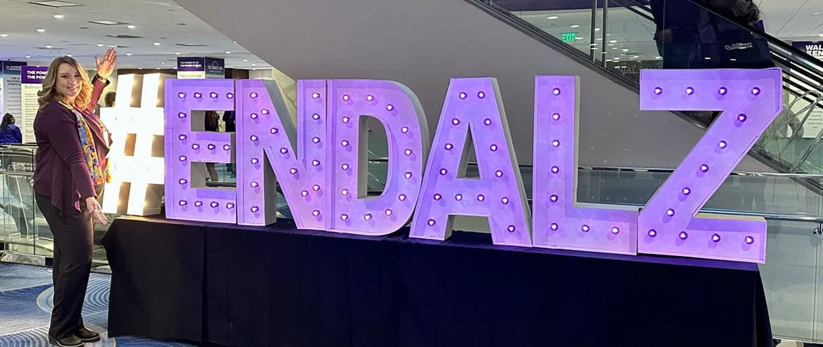 Purple Alzheimer’s awareness sign displayed on a table