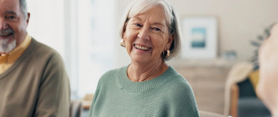 Older adult sitting looking thoughtful