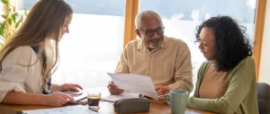 Older couple reviewing financial documents at kitchen table