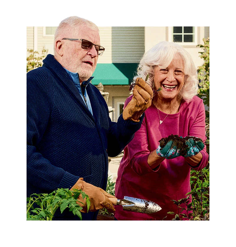Seniors smiling while gardening