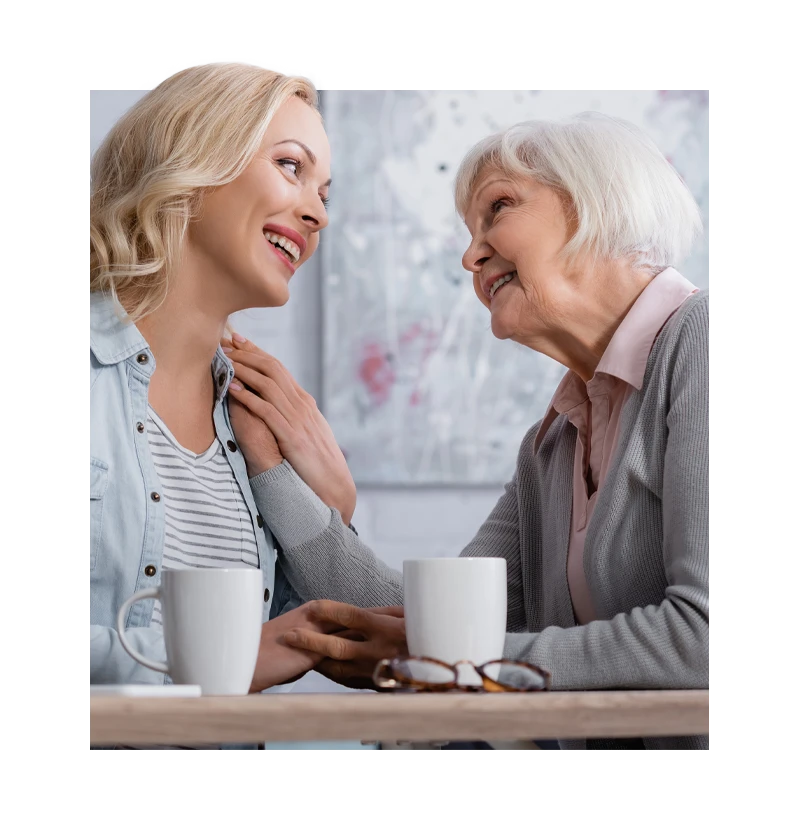 Senior having tea with woman