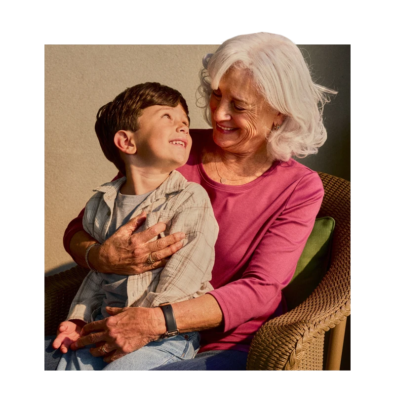 Senior smiling while holding grandchild
