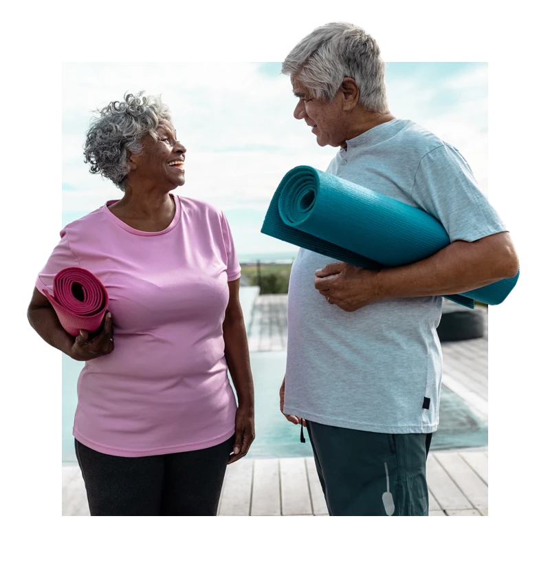 Seniors holding yoga mats