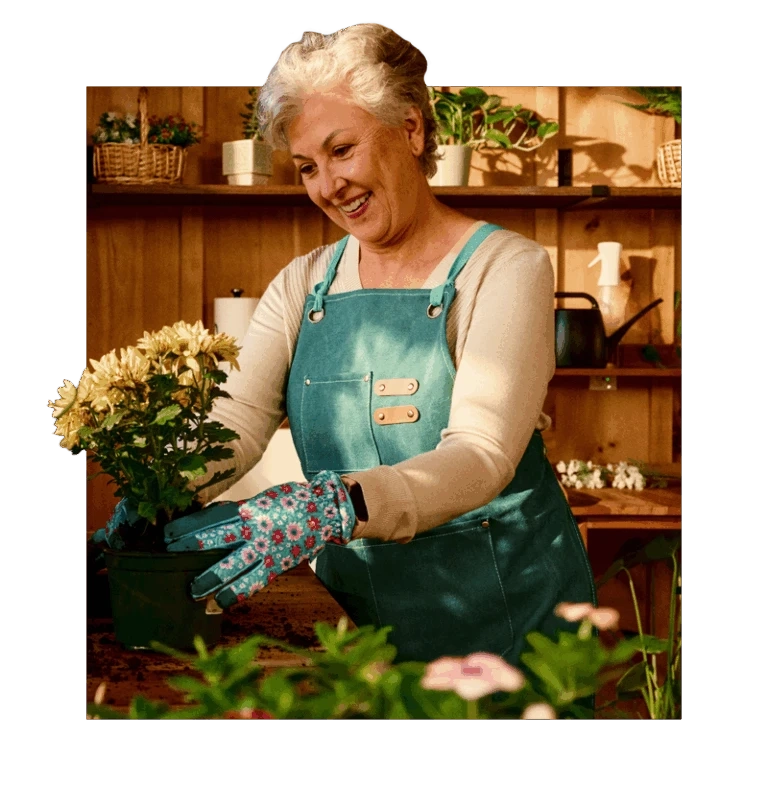 Senior holding flowers while gardening